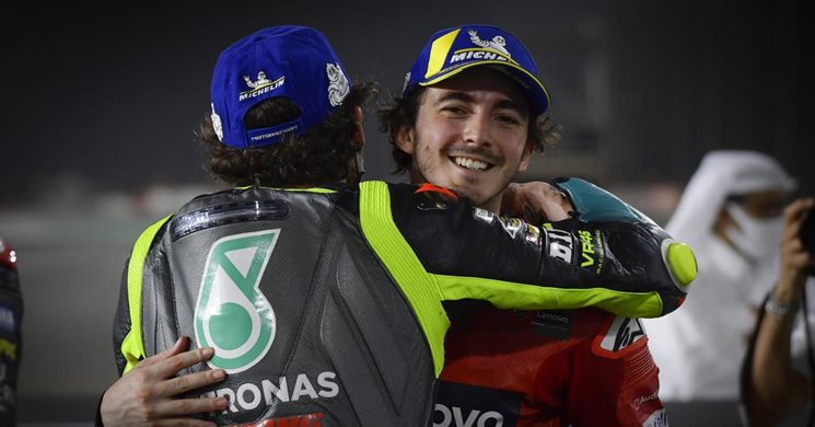 Un abbraccio tra Pecco Bagnaia e Valentino Rossi (di schiena).