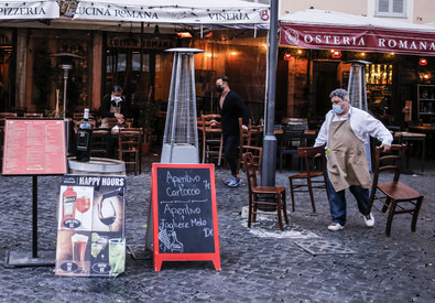Un ristoratore di fronte al suo negozio a Roma.