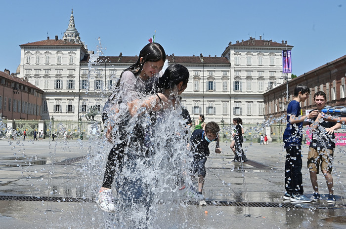 Ritonro alla normalità ragazzi si rinfrescano nelle fontane di Piazza Vastello nei primi giorni di grande caldo, Torino