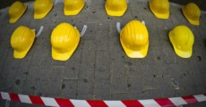 Manifestazione contro gli incidenti sul lavoro, caschi gialli a terra.