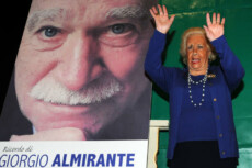Donna Assunta Almirante saluta vicino al ritratto del marito al Teatro San Babila di Milano, 6 marzo 2011, per le commemorazioni del fondatore dell'Msi Giorgio Almirante.